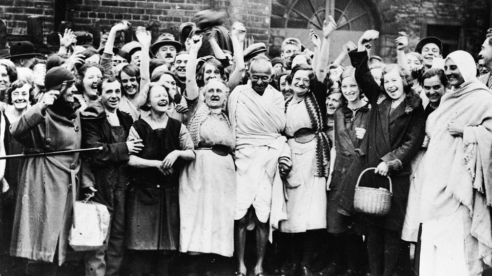 Gandhi greeted by a group of women textile workers