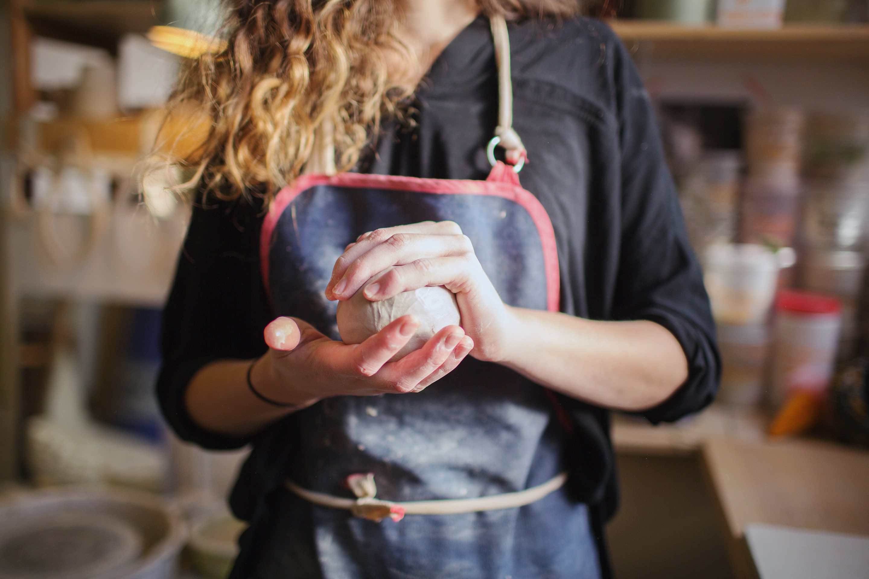 woman holding ceramic clay ball